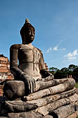Ayutthaya, Thailand. Wat Mahathat, Buddha statue of the gallery enclosing the collapsed central prang. 